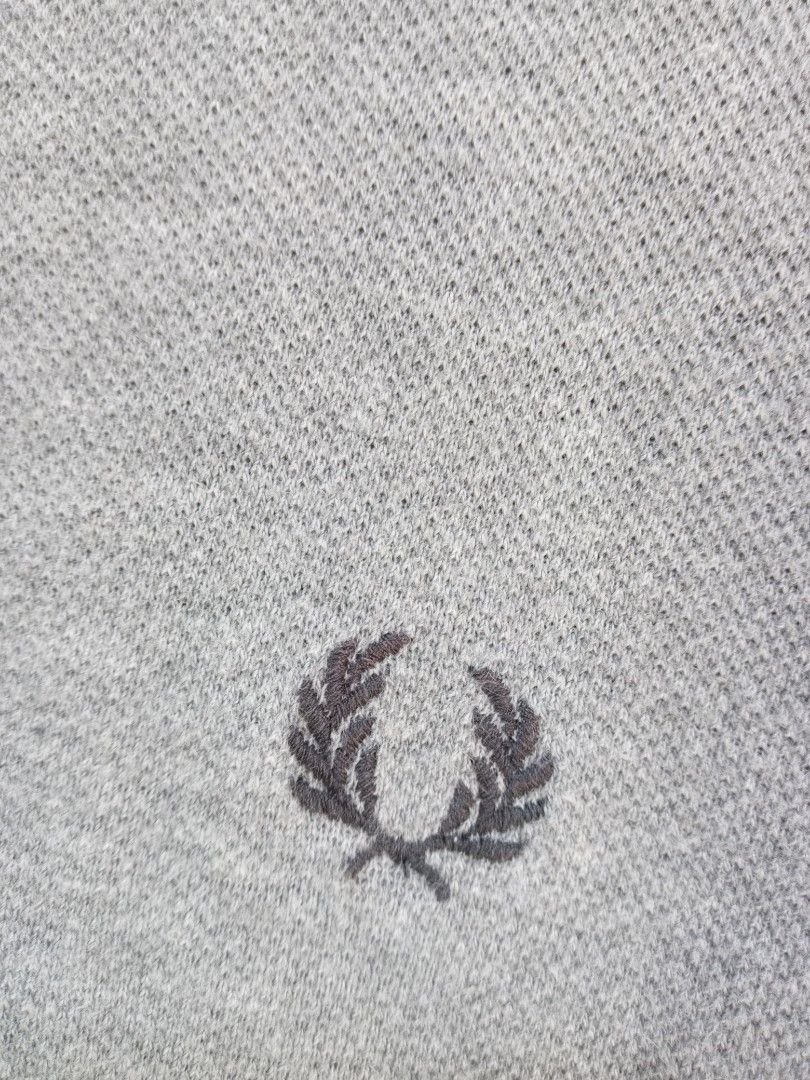 Fred Perry Polo Shirt M1200 Grey Medium (Category: Tshirts & Polo Shirts ) located in Manila. Submitted by onewikstraight (Listing ID 1470599490, Image 3). Description: - Brand: Fred Perry - Style Code: M1200/056 - Size: Medium (M) - Color: Grey with contrast tipping - Material: Classic cotton pique fabric - Details: Ribbed collar and cuffs, branded placket buttons, embroidered laurel wreath on chest - Origin: Green interior neck label denoting U