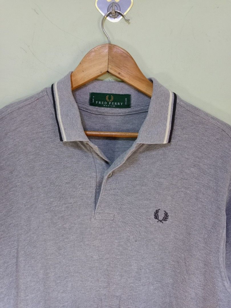 Fred Perry Polo Shirt M1200 Grey Medium (Category: Tshirts & Polo Shirts ) located in Manila. Submitted by onewikstraight (Listing ID 1470599490, Image 2). Description: - Brand: Fred Perry - Style Code: M1200/056 - Size: Medium (M) - Color: Grey with contrast tipping - Material: Classic cotton pique fabric - Details: Ribbed collar and cuffs, branded placket buttons, embroidered laurel wreath on chest - Origin: Green interior neck label denoting U