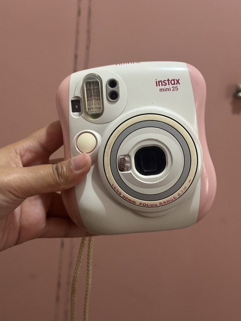 Fujifilm Instax Mini 25 Pink White Instant Camera (Category: Cameras) located in Cavite. Submitted by thriftbymari (Listing ID 1470562059, Image 1). Description: with battery rfs: hindi na nagagamit loc: cavite.