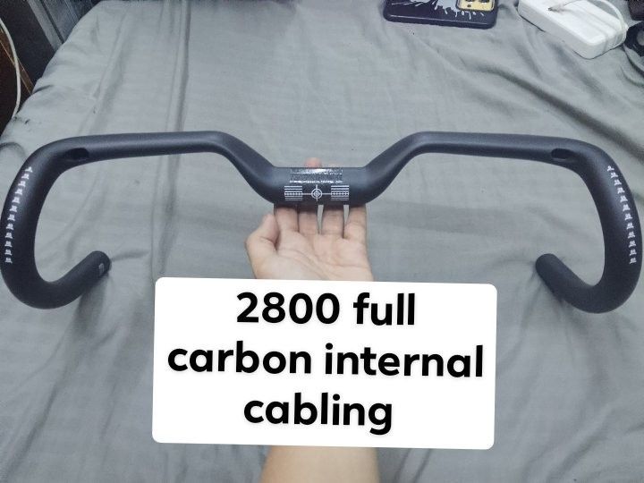 Full Carbon Internal Cabling Bicycle Handlebar (Category: Bicycles) located in Quezon City. Submitted by xjoelouise (Listing ID 1470592330, Image 1). Description: - Full carbon handlebar supporting internal cabling - Lightweight drop bar setup for road bikes - Ergonomic top section for comfortable riding - Textured clamp area for secure installation - Clean matte black finish.