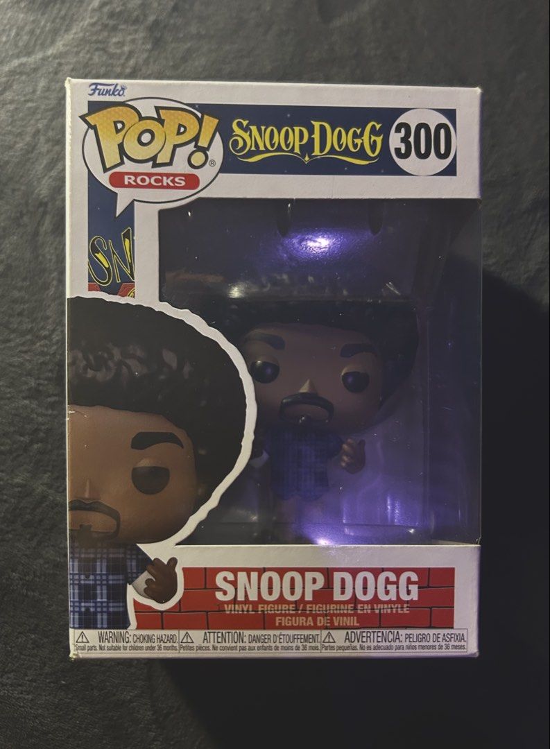 Funko Pop! Rocks Snoop Dogg #300 (Category: Designer & Blind Box Toys) located in Las Pinas. Submitted by 1tzmothafvckinmcshop (Listing ID 1470724441, Image 1). Description: original funko pop! rocks snoop dogg #300, featuring his afro hairstyle, blue plaid shirt, and khaki pants. inspired by his early ’90s west coast hip-hop era. condition: pre-owned, minor box creases and corner wear. inclusions: vinyl figure, original box, and clear plastic pr
