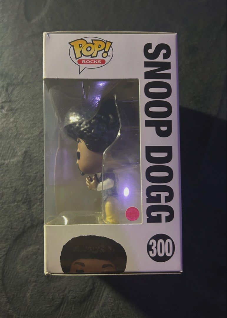 Funko Pop! Rocks Snoop Dogg #300 (Category: Designer & Blind Box Toys) located in Las Pinas. Submitted by 1tzmothafvckinmcshop (Listing ID 1470724441, Image 2). Description: original funko pop! rocks snoop dogg #300, featuring his afro hairstyle, blue plaid shirt, and khaki pants. inspired by his early ’90s west coast hip-hop era. condition: pre-owned, minor box creases and corner wear. inclusions: vinyl figure, original box, and clear plastic pr