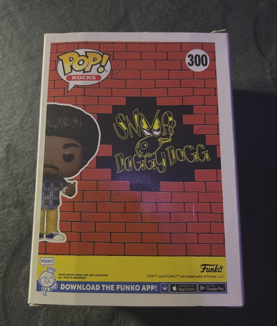 Funko Pop! Rocks Snoop Dogg #300 (Category: Designer & Blind Box Toys) located in Las Pinas. Submitted by 1tzmothafvckinmcshop (Listing ID 1470724441, Image 3). Description: original funko pop! rocks snoop dogg #300, featuring his afro hairstyle, blue plaid shirt, and khaki pants. inspired by his early ’90s west coast hip-hop era. condition: pre-owned, minor box creases and corner wear. inclusions: vinyl figure, original box, and clear plastic pr