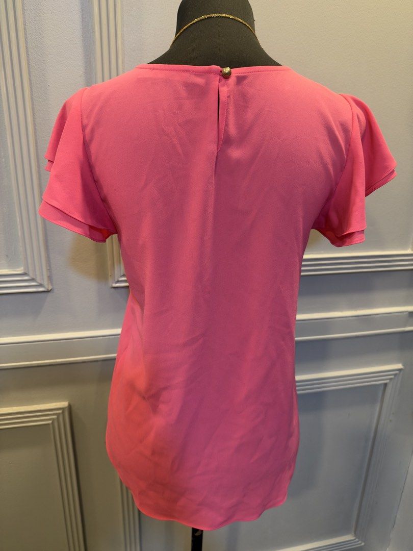 G2000 Pink Flutter Sleeve Blouse Size 32 (Category: Blouses) located in Manila. Submitted by anjcuenca (Listing ID 1470693321, Image 2). Description: - Brand: G2000 - Size: 32 - Color: Bright pink - Material: Lightweight crepe fabric - Design: Double-layered flutter sleeves with soft neckline pleats - Details: Round collar, back button keyhole cutout, and a versatile curved hem - Condition: Excellent, ready to wear!.