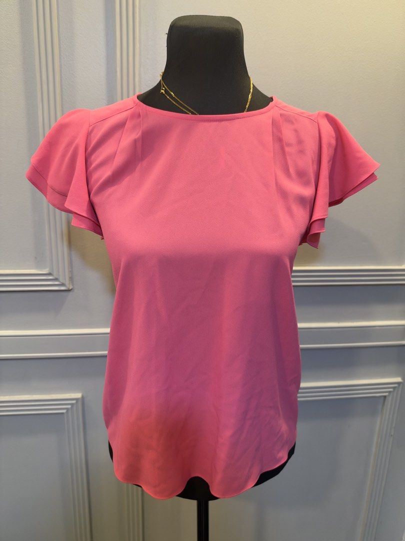 G2000 Pink Flutter Sleeve Blouse Size 32 (Category: Blouses) located in Manila. Submitted by anjcuenca (Listing ID 1470693321, Image 1). Description: - Brand: G2000 - Size: 32 - Color: Bright pink - Material: Lightweight crepe fabric - Design: Double-layered flutter sleeves with soft neckline pleats - Details: Round collar, back button keyhole cutout, and a versatile curved hem - Condition: Excellent, ready to wear!.