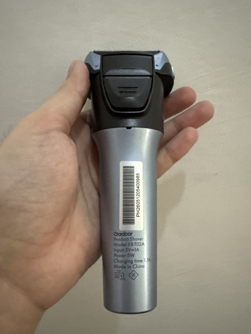 Gaabor Shaver Model ER-T02A Electric Shaver (Category: Men's Grooming) located in Bulacan. Submitted by josherue (Listing ID 1470742159, Image 2). Description: - Model: Gaabor Electric Shaver ER-T02A (Silver & Black) - Condition: Like new, used once, with original box and protective cover - Battery Life: Up to 70 minutes of continuous use - Charging Time: Fast 1.5-hour full charge - Power: 5W high-efficiency motor - Waterproof: IPX7 rating for ea