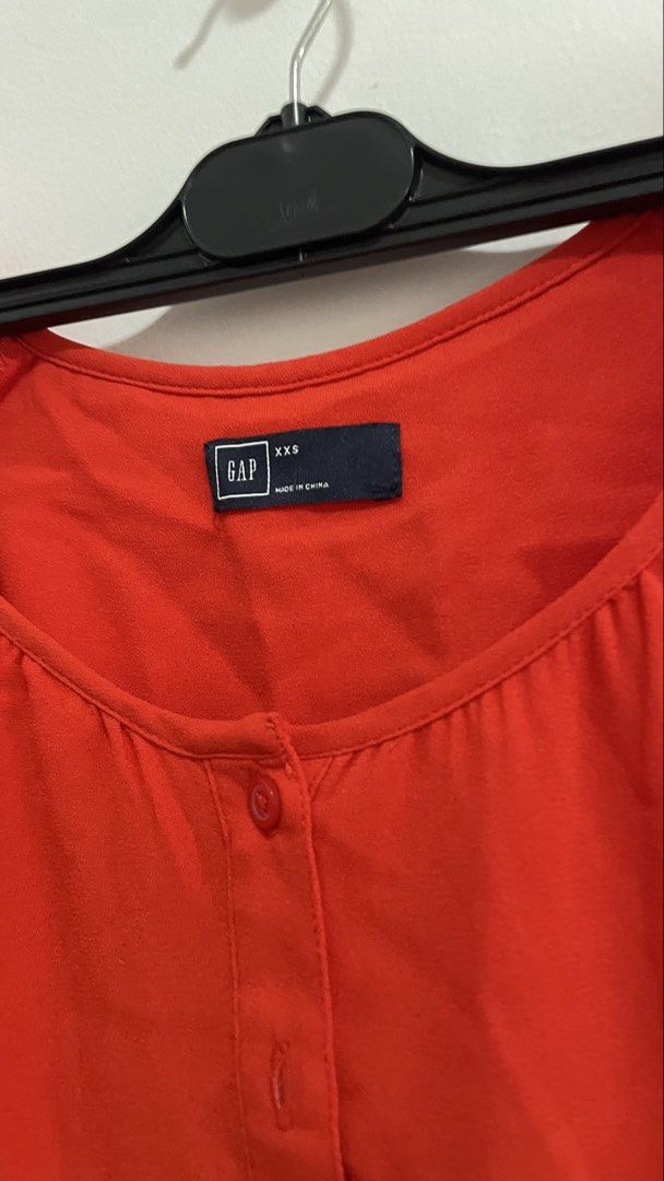 Gap Red Long Sleeve Dress (Category: Dresses) located in Indang. Submitted by itsginnpom (Listing ID 1470580872, Image 2). Description: Brand: Gap Color: Red orange-y Size: XXS Material: Light fabric Design: Long sleeves with front button placket and curved hemline Fit: Adjustable drawstring waist tie Condition: Excellent/New • used once only for school event.