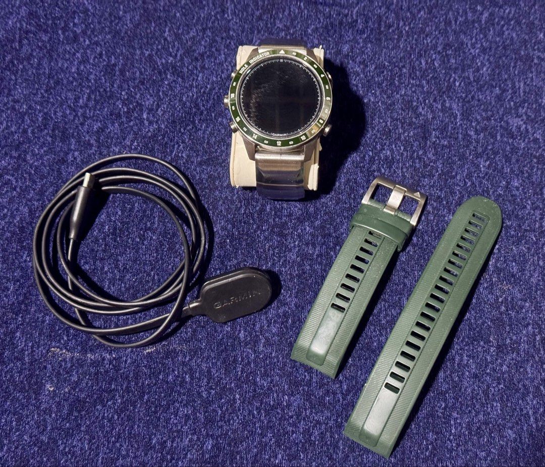 Garmin MARQ Golfer Gen 2 Smartwatch (Category: Wearables & Smart Watches) located in Quezon City. Submitted by angace13 (Listing ID 1470616463, Image 3). Description: - Model: Garmin MARQ Golfer Gen 2 GPS Smartwatch - Condition: Preowned, minor wear on the metal band and case back, screen works perfectly - Features: Green bezel with hole indicator markings - Inclusions: Metallic bracelet, extra green silicone strap, charging cable - Ideal for gol