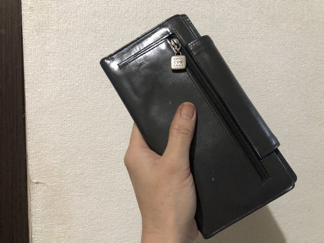 Gazzomani Dark Grey Long Wallet (Category: Wallets & Card holders) located in Valenzuela. Submitted by nixs2722 (Listing ID 1470705267, Image 2). Description: - Brand/Model: Gazzomani long wallet in dark grey - Finish: Textured with snap closure - Exterior: Metal hardware plate on front with visible scratches and wear; back zip pocket with a custom zip pull - Interior: Multiple card slots and an ID window - Condition: Used with noticeable signs o