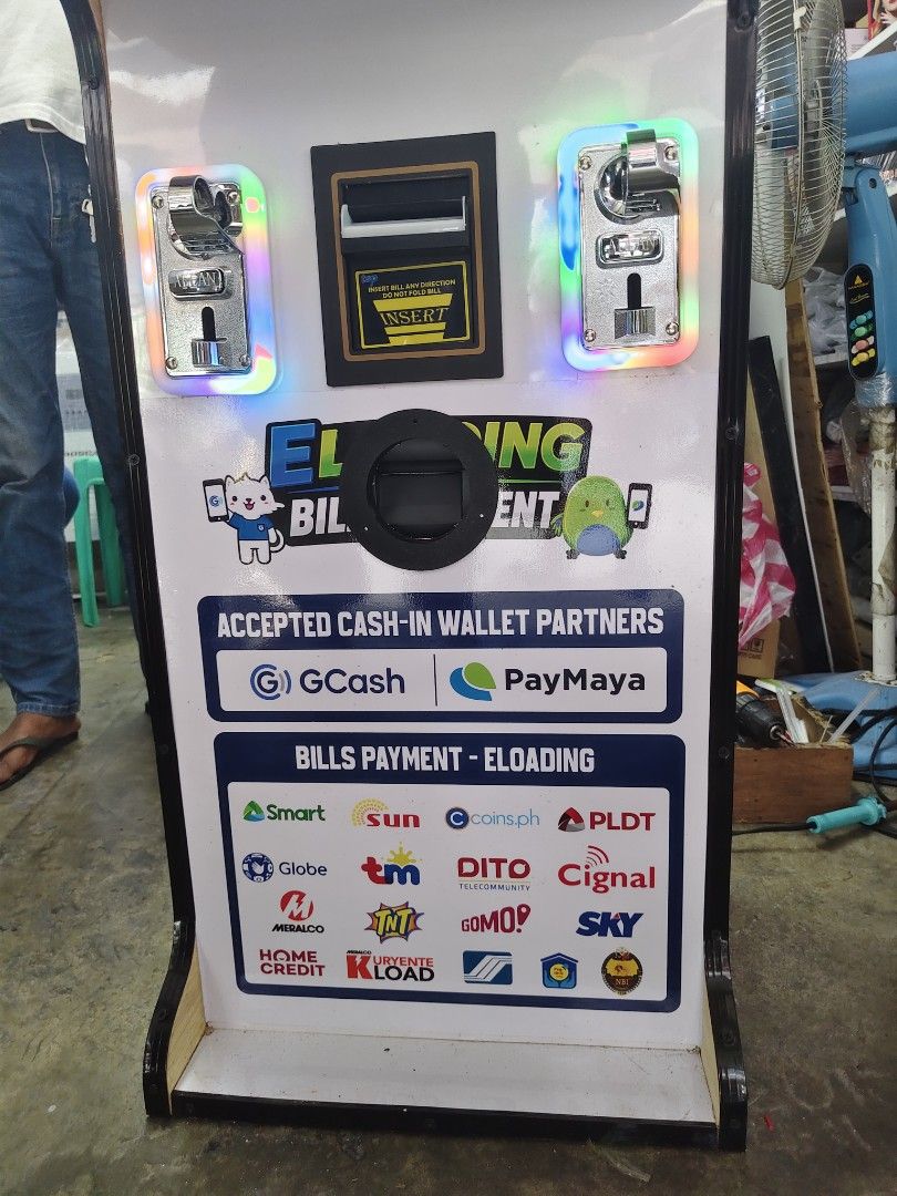 GCash Cash-In Pay Bills and E-Loading Machine Kiosk (Category: Office & Business Technology) located in Manila. Submitted by engrkkkk (Listing ID 1470641281, Image 3). Description: - All-in-one business machine for GCash, PayMaya, and e-loading - Supports bill payments for Smart, Globe, Sun, PLDT, Cignal, Sky, and more - Equipped with a touchscreen monitor, bill acceptor, and coin slots - Comes with fully functional signage and body graphics - Pe