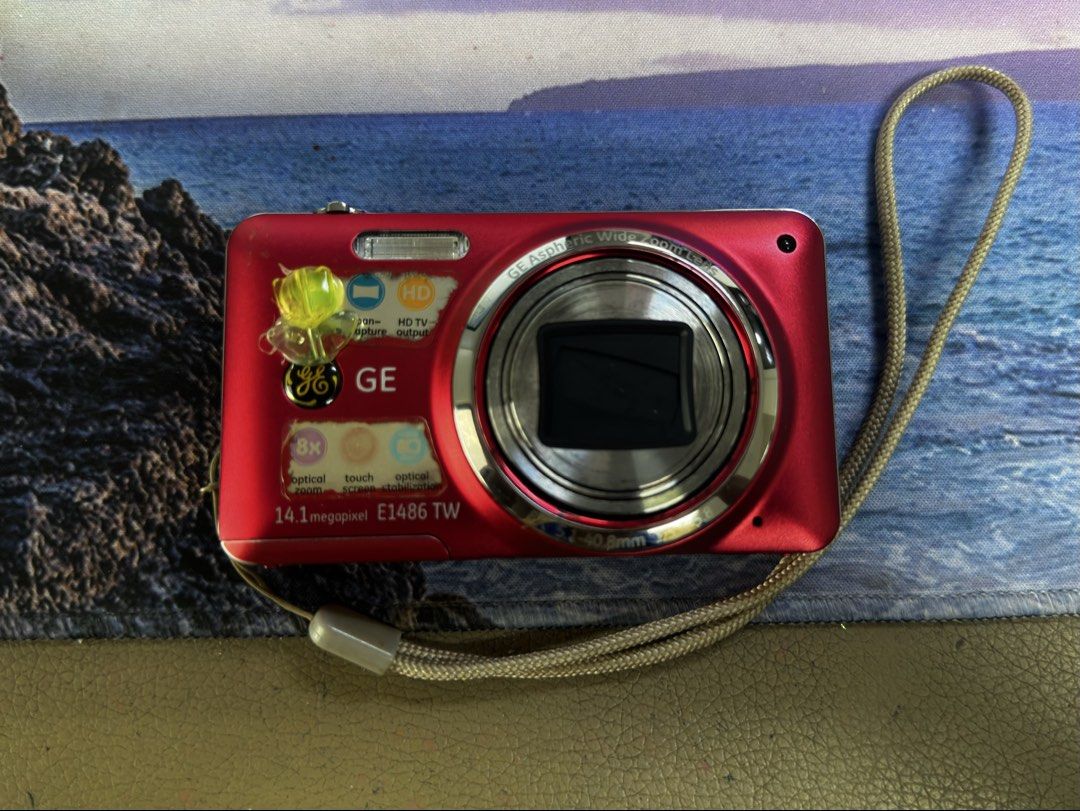 GE E1486 TW 14.1MP Digital Camera Red (Category: Cameras) located in Marikina City. Submitted by patriciaoriendo2 (Listing ID 1470571080, Image 1). Description: - Model: Red GE E1486 TW Digital Camera - Resolution: 14.1 Megapixels with 8x optical zoom - Condition: Fully functional buttons and lens; minor scuffs and wear along body edges from regular use - Storage: Uses standard SD cards - Inclusions: Original wrist strap and a durable black Lowep