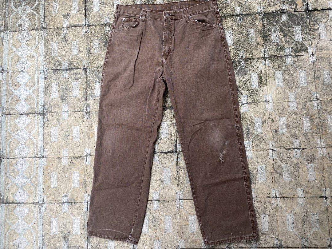 Genuine Dickies brown carpenter work pants (Category: Jeans) located in Imus. Submitted by frootiloots4103 (Listing ID 1470717556, Image 1). Description: - Brand: Genuine Dickies - Color: Brown - Material: Durable cotton blend, machine washable - Fit: Relaxed fit through the leg - Details: Button closure with metal hardware, multiple back pockets including a utility tool pocket - Condition: Slight fade with a small, character-adding distress mark