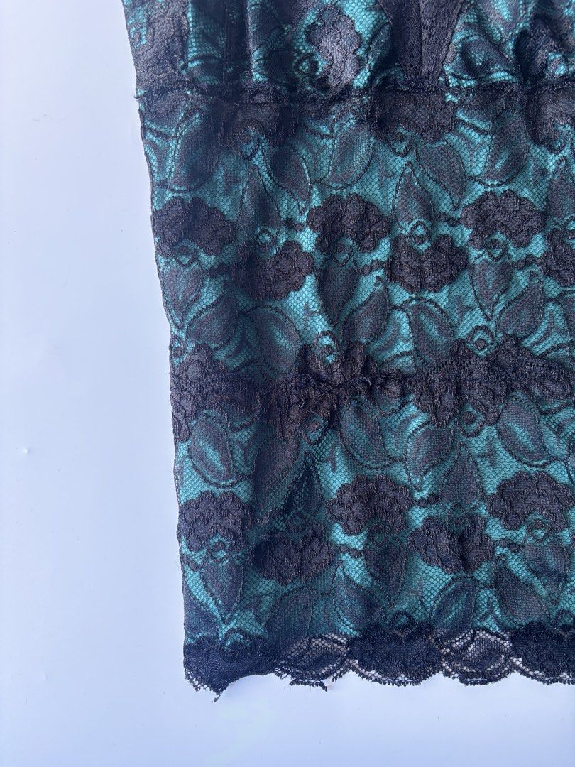 George Stretch Teal Lace Cami Top (Category: Sleeveless) located in Batac City. Submitted by doniagel (Listing ID 1470634085, Image 3). Description: - Brand: George - Size: M to L (12/14) - Color: Teal and black - Material: Lace overlay (95% nylon, 5% spandex) with inner cotton-spandex layer - Design: V-neckline with scalloped lace trim - Origin: Made in Guatemala - Versatility: Great layering piece or standalone going-out top.