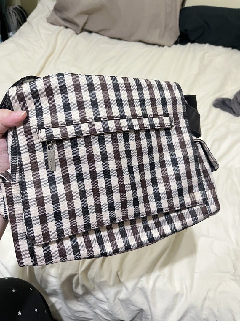 Gingham Checkered Messenger Shoulder Bag (Category: Shoulder Bags) located in Quezon City. Submitted by rrsalaum (Listing ID 1470711525, Image 1). Description: - Brown and white gingham checkered design - Made from sturdy canvas material with a structured shape - Zippered front flap pocket and convenient side pockets - Adjustable black strap equipped with a comfortable shoulder pad - Ideal for daily casual use or school.