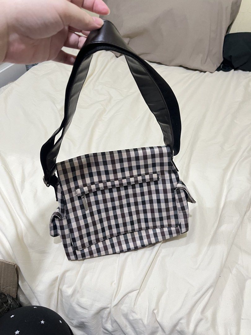 Gingham Checkered Messenger Shoulder Bag (Category: Shoulder Bags) located in Quezon City. Submitted by rrsalaum (Listing ID 1470711525, Image 2). Description: - Brown and white gingham checkered design - Made from sturdy canvas material with a structured shape - Zippered front flap pocket and convenient side pockets - Adjustable black strap equipped with a comfortable shoulder pad - Ideal for daily casual use or school.