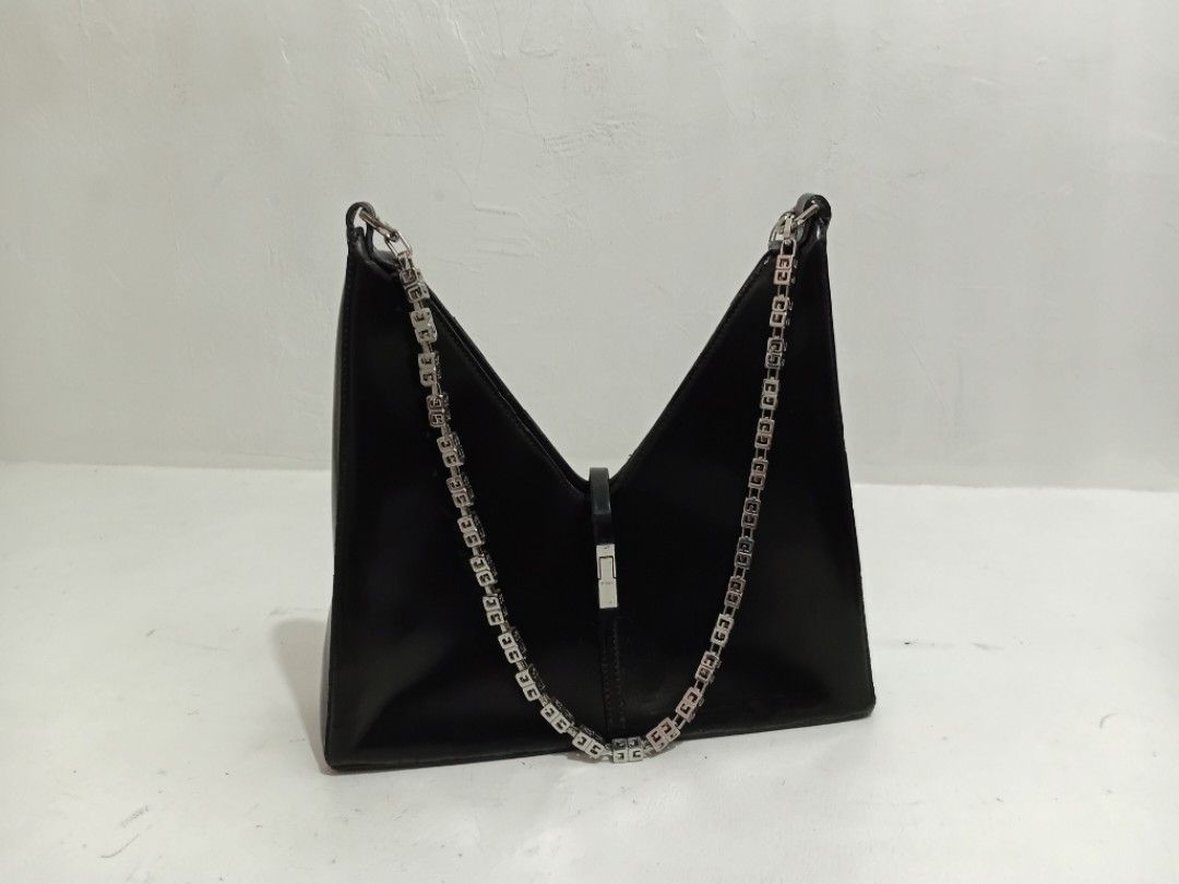 Givenchy Cut Out black Shoulder bag (Category: Luxury Bags & Wallets) located in Navotas City. Submitted by ms.soulana (Listing ID 1470630598, Image 2). Description: PreOwned lighlty Used WellUsed Givenchy Cut out Black Shoulder bag Medium Leather - Hardware: Silver-tone with signature G-cube chain strap - Design: Sharp V-shaped silhouette, structured base, and vertical center seam with padlock-style clasp - Interior: Clean lining - Condition: Mi