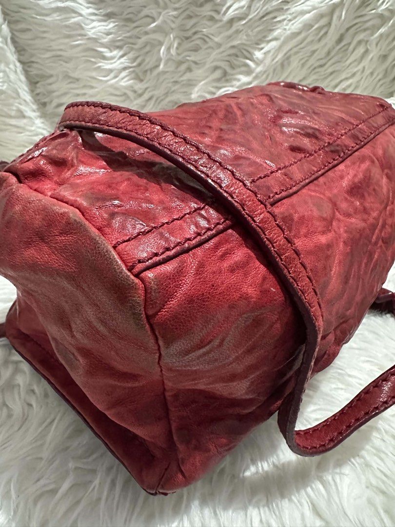 Givenchy Pandora Red Leather Crossbody Bag (Category: Luxury Bags & Wallets) located in Bustos. Submitted by theprelovedshopbulacan (Listing ID 1470704479, Image 3). Description: Givenchy Pandora shoulder bag in crinkled red leather. Gold tone zippers and hardware with dual zip top closure. Fabric lined interior featuring a zippered pocket and debossed logo tag. Adjustable crossbody strap attached. Minor wear on corners and edges from normal carr