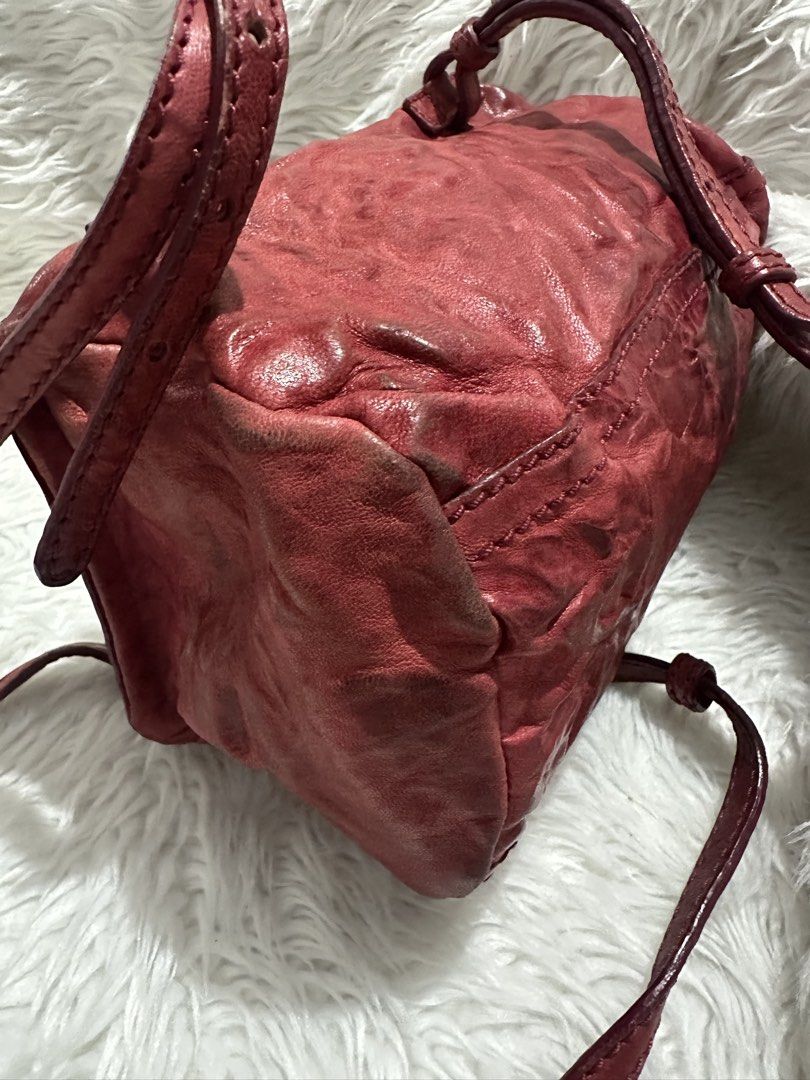 Givenchy Red Leather Pandora Mini Crossbody Bag (Category: Luxury Bags & Wallets) located in Marilao. Submitted by curleylux (Listing ID 1470586768, Image 3). Description: Givenchy Pandora crossbody bag in crinkled red leather. Gold tone hardware and zipper closures. Bold GIVENCHY logo lettering stamped across the front. Adjustable thin strap attached. Boxy silhouette with slight softening at the corners. Minor darkening and scuffing along the lo