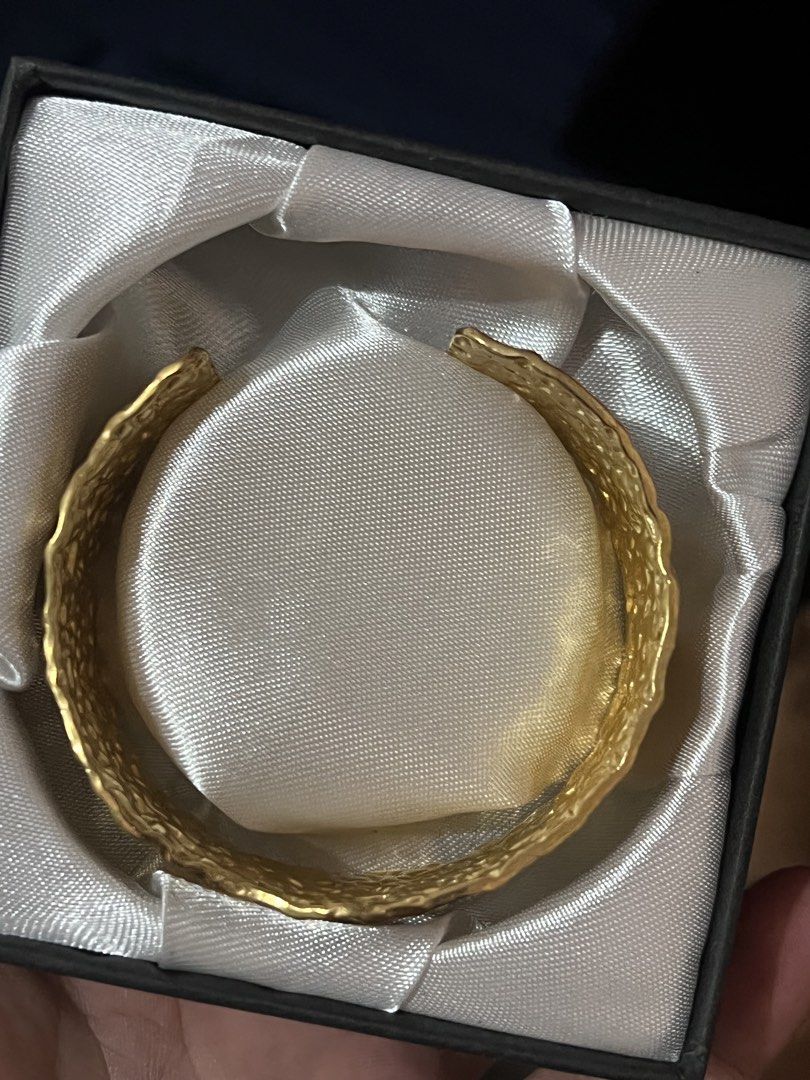 Gold-Tone Textured Cuff Bracelet with Gift Box (Category: Bracelets) located in Manila. Submitted by cleverstone_21f597 (Listing ID 1470609247, Image 3). Description: - Gold-tone metal cuff bracelet with a stylish textured, hammered finish - Wide band design featuring an open back for easy sliding on and off - Excellent, clean condition with no scratches or tarnishing - Comes securely stored in a luxurious black presentation box lined with white 