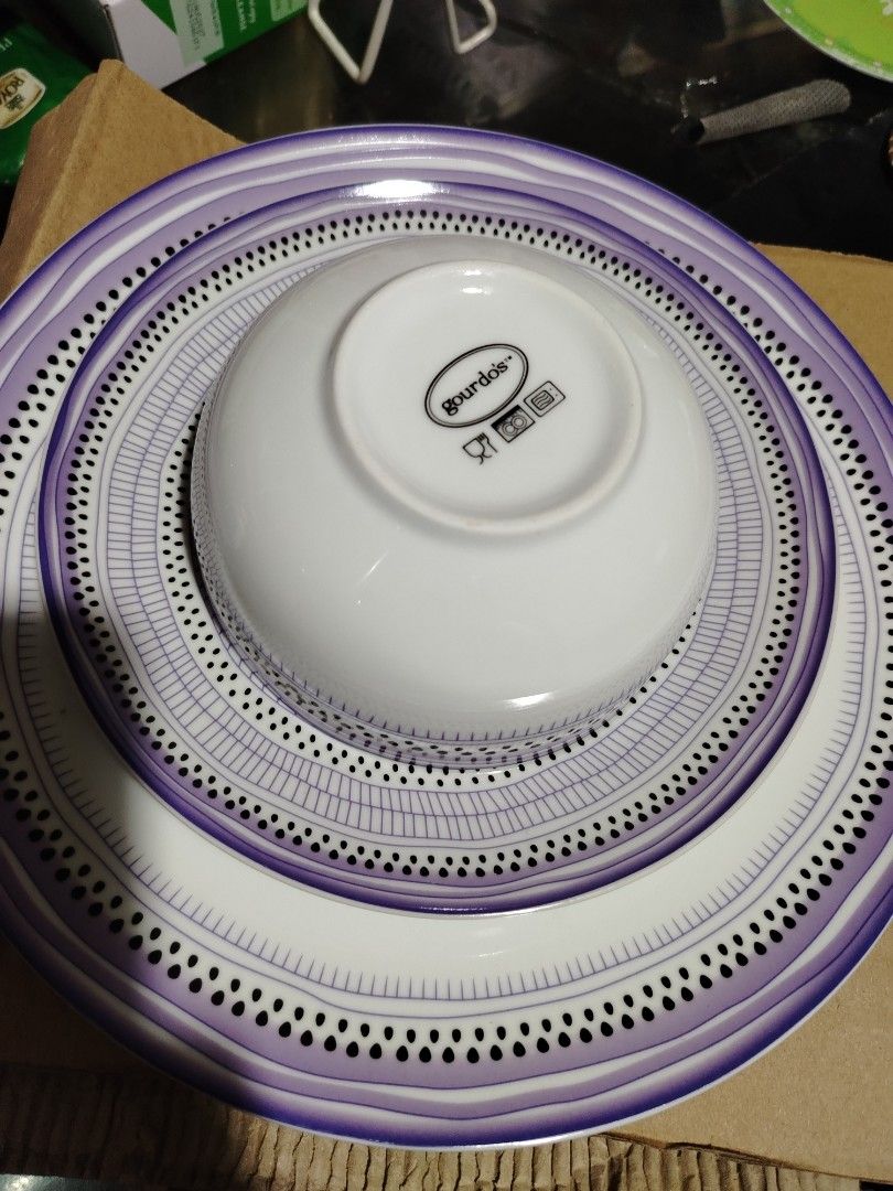 Gourdo's Purple Pattern Dinner Plates Bowl and Mug Set (Category: Dinnerware & Cutlery) located in Quezon City. Submitted by shewool (Listing ID 1470591148, Image 3). Description: Matching dinnerware set from Gourdo's. Includes large plates, smaller plates, a deep bowl, and a mug with a handle. Purple and black patterned trim design on white ceramic. Microwave and dishwasher safe symbols printed on the bottom bases. Great for daily meals or hosti