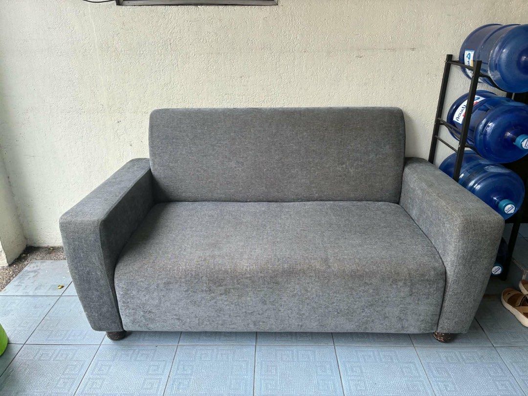 Gray 2 Seater Fabric Sofa (Category: Sofas) located in Pasig City. Submitted by jorgeboy9748 (Listing ID 1470571934, Image 2). Description: - 2-seater sofa in a versatile dark gray fabric - Clean lines and simple, modern design - Compact size ideal for smaller spaces like living rooms, studies, or bedrooms - Solid armrests and supportive backrest for maximum comfort - Built on a sturdy frame with stylish short wooden feet - Clean and well-maintai