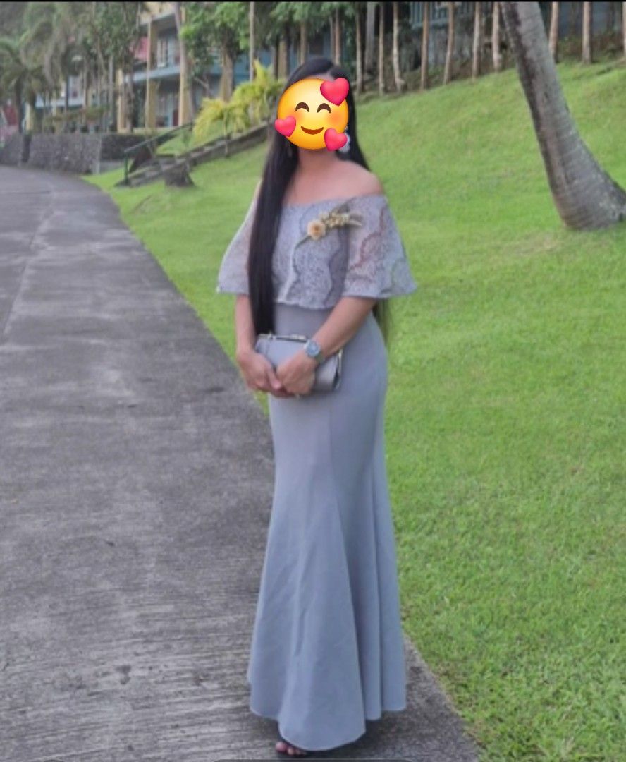 Gray Long Dress Formal Gown (Category: Evening dresses & gowns) located in Quezon City. Submitted by sufficientgraceforever (Listing ID 1470712584, Image 1). Description: - Style: Long grey formal gown with a flattering mermaid silhouette - Design: Off-shoulder neckline, sheer lace bodice overlay, short ruffled sleeves, and a chic floral brooch - Length: Floor-length with a flared bottom - Condition: Great - Best For: Evening parties, weddings, a