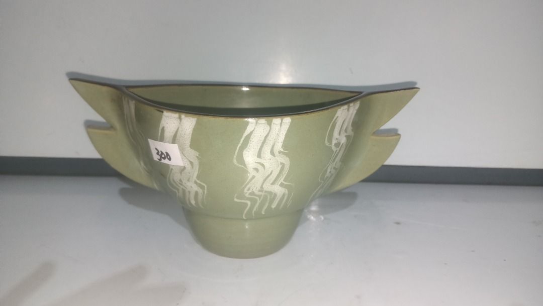 Green Ikebana Ceramic Fish Shaped Serving Bowl (Category: Dinnerware & Cutlery) located in Munoz. Submitted by larryc1212 (Listing ID 1470632416, Image 1). Description: - Product: Green ceramic fish-shaped bowl - Design: White pattern along the body with a dark open rim - Dimensions: Approx. 4 inches tall and 9 inches long - Base: Features a sturdy footed base at the bottom - Condition: Brand new with store price tag - Great for home decor, table