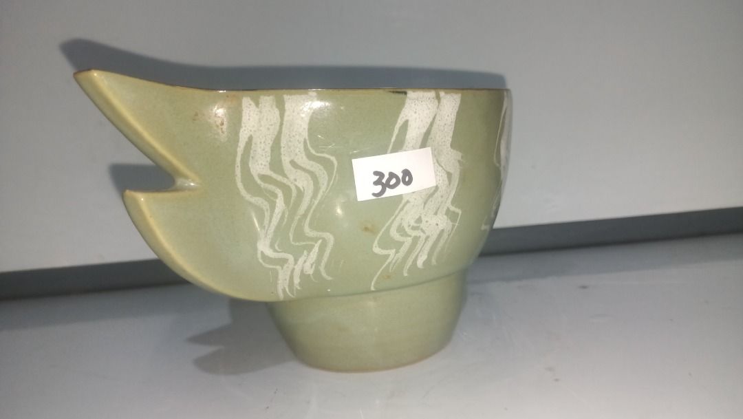 Green Ikebana Ceramic Fish Shaped Serving Bowl (Category: Dinnerware & Cutlery) located in Munoz. Submitted by larryc1212 (Listing ID 1470632416, Image 3). Description: - Product: Green ceramic fish-shaped bowl - Design: White pattern along the body with a dark open rim - Dimensions: Approx. 4 inches tall and 9 inches long - Base: Features a sturdy footed base at the bottom - Condition: Brand new with store price tag - Great for home decor, table