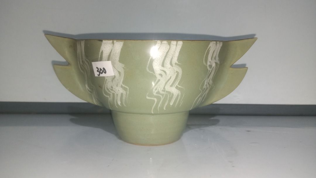 Green Ikebana Ceramic Fish Shaped Serving Bowl (Category: Dinnerware & Cutlery) located in Munoz. Submitted by larryc1212 (Listing ID 1470632416, Image 2). Description: - Product: Green ceramic fish-shaped bowl - Design: White pattern along the body with a dark open rim - Dimensions: Approx. 4 inches tall and 9 inches long - Base: Features a sturdy footed base at the bottom - Condition: Brand new with store price tag - Great for home decor, table
