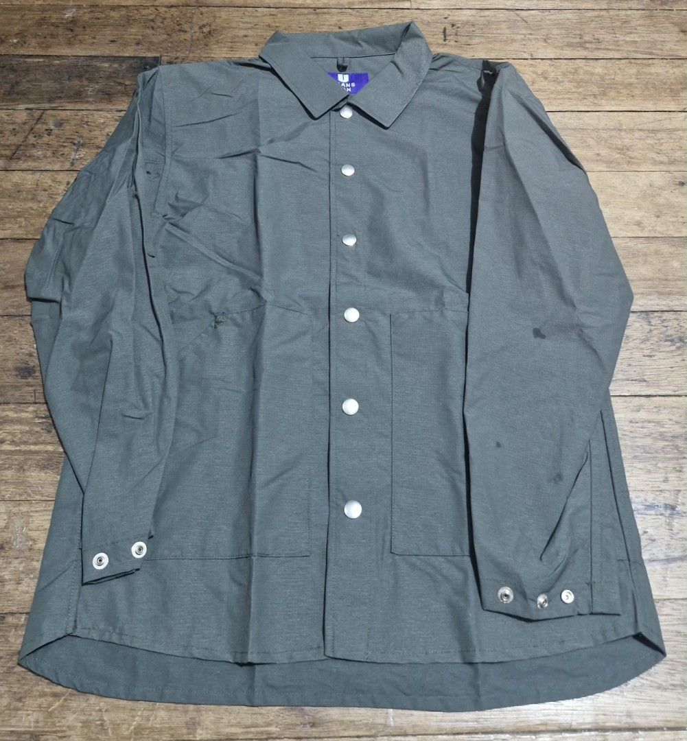 Green long sleeve button-up utility shirt (Category: Coats, Jackets and Outerwear) located in Manila. Submitted by martinezjonill (Listing ID 1470584765, Image 1). Description: - Color: Army green - Closure: Snap buttons down the front - Pockets: Two front pockets near the hem - Cuffs: Adjustable snap cuffs on both sleeves - Fabric: Lightweight, great for layering - Details: Collared neckline with a purple label inside the collar washable stain c