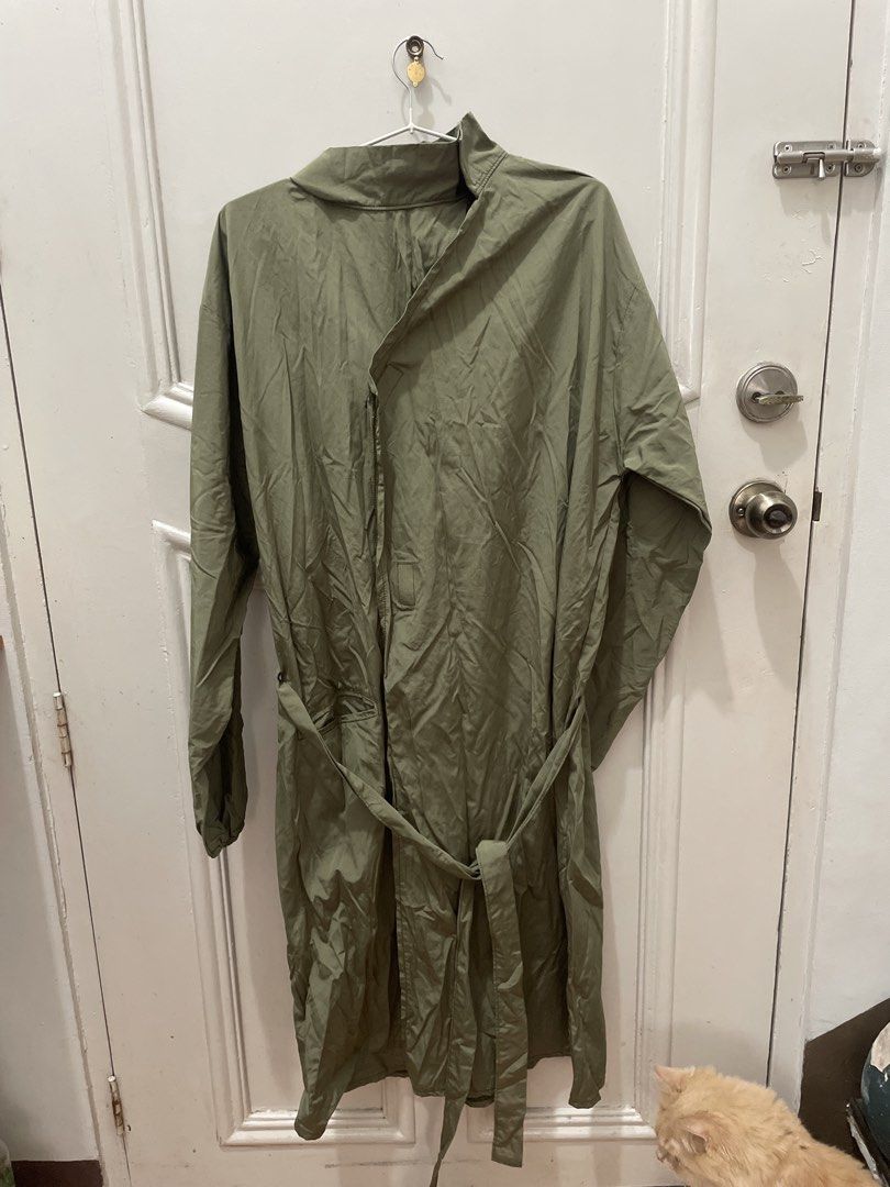 Green Raincoat Trench Coat with Belt (Category: Coats, Jackets and Outerwear) located in Cainta. Submitted by nancygoreng (Listing ID 1470624908, Image 1). Description: - Color: Army green - Style: Mid-length with a matching fabric tie belt - Closure: Button-up front with a high collar - Cuffs: Elastic on both sleeves - Material: Lightweight and easy to fold/pack - Design: Simple solid color.