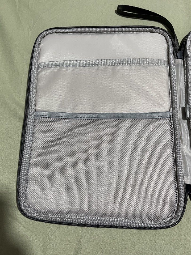 Grey Document Organizer Bag with Zipper and Hand Strap (Category: Laptop Bags & Sleeves) located in Bulacan. Submitted by love.aya (Listing ID 1470702533, Image 3). Description: - Color: Dark Grey - Material: Durable build with smooth all-around zipper closure - Portability: Features a sturdy side hand strap for easy carrying - Interior Storage: Includes a zippered mesh pocket, open slip pockets and padded compartments - Perfect For: Keeping your