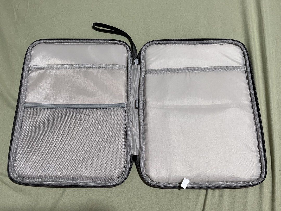 Grey Document Organizer Bag with Zipper and Hand Strap (Category: Laptop Bags & Sleeves) located in Bulacan. Submitted by love.aya (Listing ID 1470702533, Image 2). Description: - Color: Dark Grey - Material: Durable build with smooth all-around zipper closure - Portability: Features a sturdy side hand strap for easy carrying - Interior Storage: Includes a zippered mesh pocket, open slip pockets and padded compartments - Perfect For: Keeping your