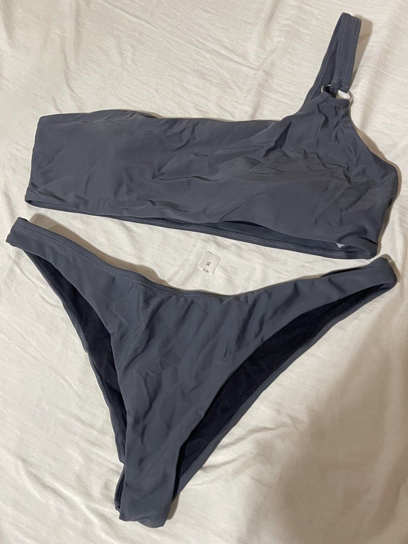 Grey One-Shoulder Bikini Set Size XL (Category: Bikinis & Swimsuits) located in Caloocan City. Submitted by sheshesheshesheshe13 (Listing ID 1470720361, Image 1). Description: - Style: Grey two-piece bikini with a trendy one-shoulder top and ring detail on the strap - Size: XL (tag attached) - Material: 80% comfortable nylon blend - Condition: Brand new, unworn - Perfect for: Beach days, pool parties, and vacations.