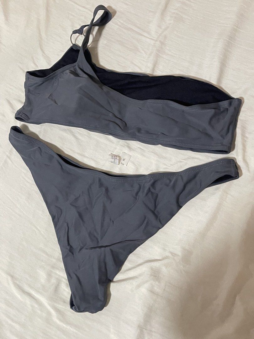 Grey One-Shoulder Bikini Set Size XL (Category: Bikinis & Swimsuits) located in Caloocan City. Submitted by sheshesheshesheshe13 (Listing ID 1470720361, Image 2). Description: - Style: Grey two-piece bikini with a trendy one-shoulder top and ring detail on the strap - Size: XL (tag attached) - Material: 80% comfortable nylon blend - Condition: Brand new, unworn - Perfect for: Beach days, pool parties, and vacations.