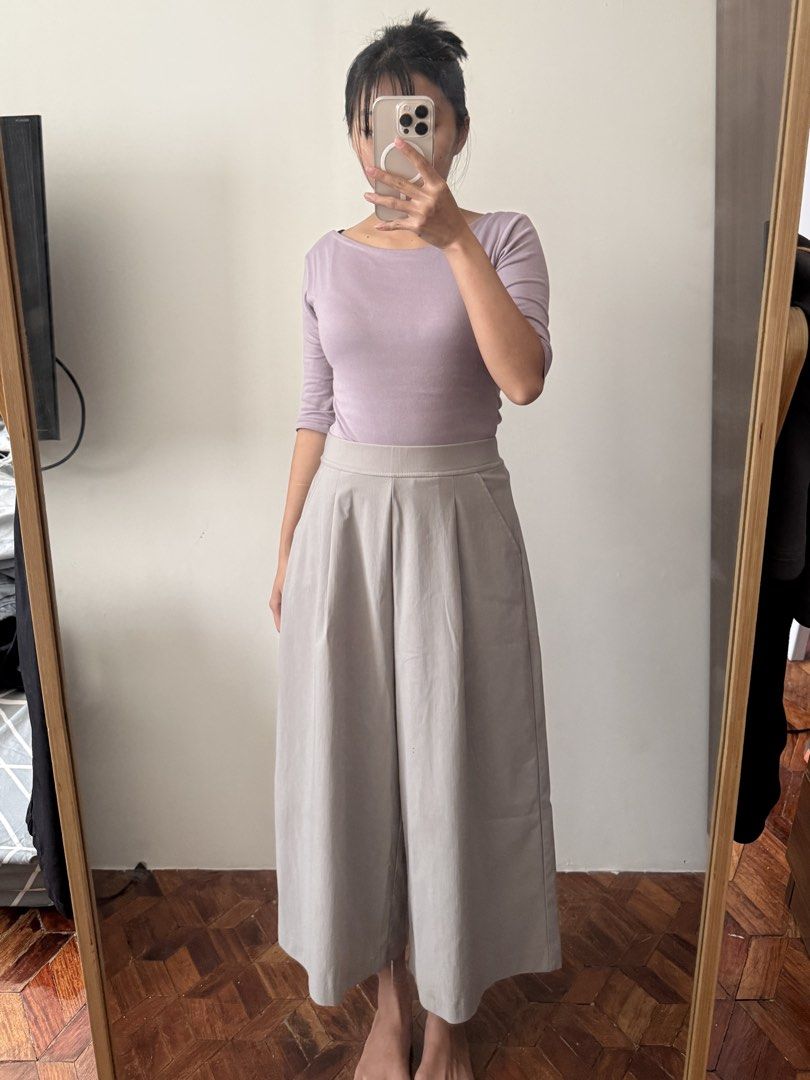 Grey wide-leg pants with pleated front (Category: Other Bottoms) located in Las Pinas. Submitted by juls_mp (Listing ID 1470622783, Image 3). Description: - Style: Grey wide-leg culotte pants - Fit: High-waist with a structured waistband and front pleats - Length: Cropped, hits around mid-calf - Features: Deep side pockets and smooth woven fabric that holds its shape well - Versatility: Easy to style for work or casual days - Condition: Brand new