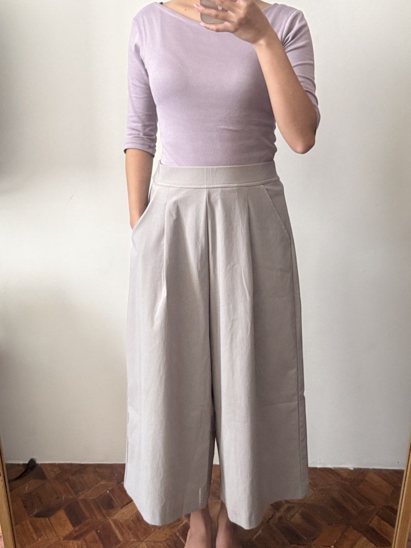 Grey wide-leg pants with pleated front (Category: Other Bottoms) located in Las Pinas. Submitted by juls_mp (Listing ID 1470622783, Image 1). Description: - Style: Grey wide-leg culotte pants - Fit: High-waist with a structured waistband and front pleats - Length: Cropped, hits around mid-calf - Features: Deep side pockets and smooth woven fabric that holds its shape well - Versatility: Easy to style for work or casual days - Condition: Brand new