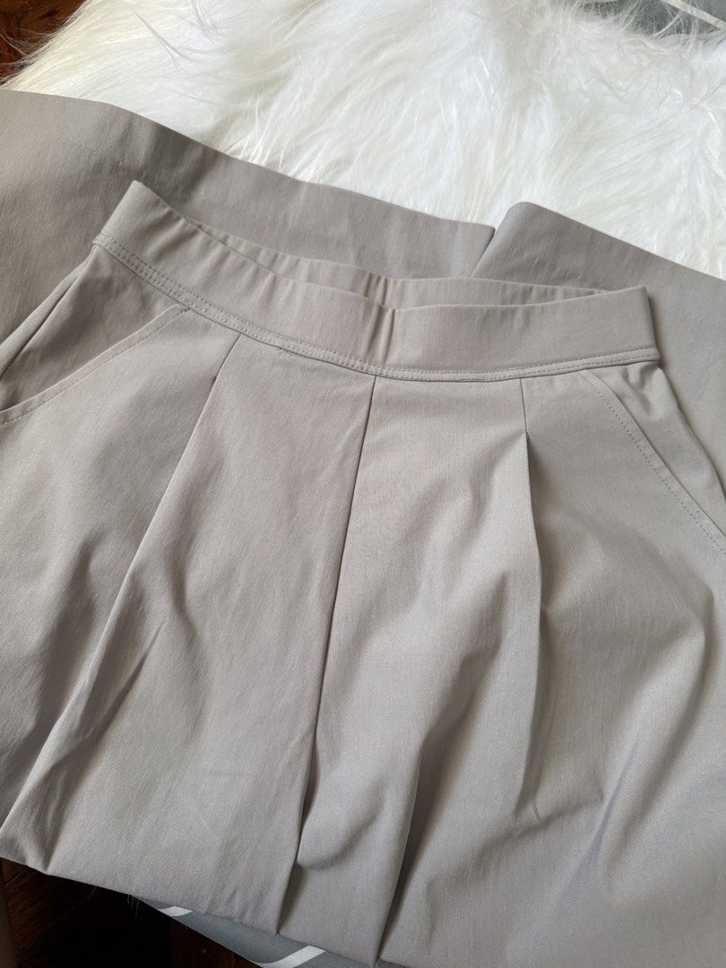 Grey wide-leg pants with pleated front (Category: Other Bottoms) located in Las Pinas. Submitted by juls_mp (Listing ID 1470622783, Image 2). Description: - Style: Grey wide-leg culotte pants - Fit: High-waist with a structured waistband and front pleats - Length: Cropped, hits around mid-calf - Features: Deep side pockets and smooth woven fabric that holds its shape well - Versatility: Easy to style for work or casual days - Condition: Brand new