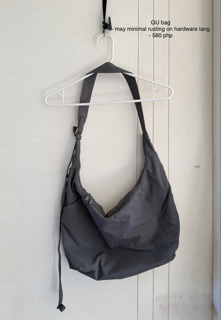 GU gray shoulder bag (Category: Shoulder Bags) located in Manila. Submitted by cinnmoroll (Listing ID 1470608382, Image 1). Description: - Brand: GU - Style: Slouchy hobo shoulder bag / everyday carryall - Color: Dark gray - Closure: Secure top zipper - Features: Roomy interior compartment and adjustable strap with metal hardware - Condition: Good, with minimal rusting on the hardware rings.