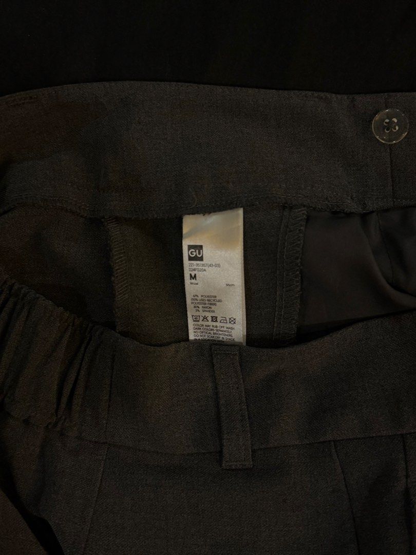 GU Pleated Wide Leg Pants Size M (Category: Trousers) located in Paranaque City. Submitted by preloveditems111 (Listing ID 1470714977, Image 3). Description: - Brand: GU - Style: Wide leg trousers with front pleats and high-waisted fit - Color: Dark grey - Size: Medium (fits 66cm waist) - Material: 67% polyester, 30% rayon, 3% spandex (features a partial elastic waistband at the back for extra comfort) - Condition: Clean and well-maintained insid