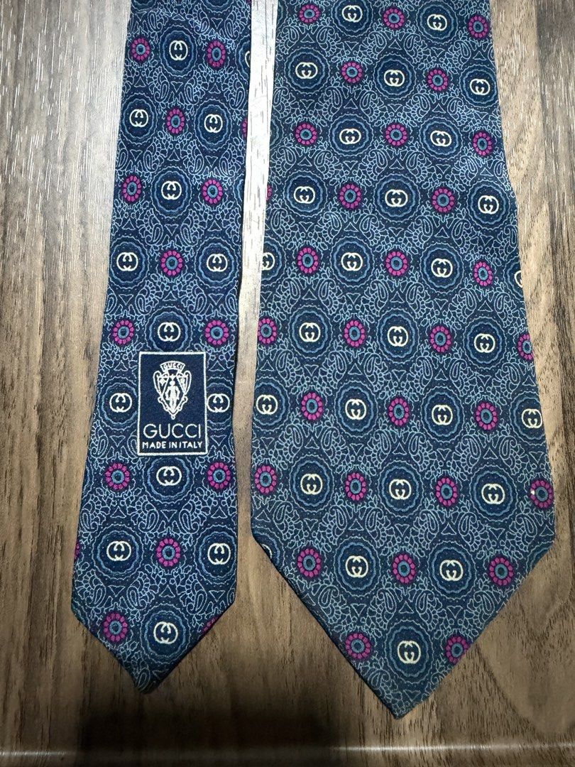 Gucci Accessory Collection Silk Tie (Category: Ties) located in Digos. Submitted by old_soul. (Listing ID 1470694961, Image 1). Description: - Brand: Gucci (Accessory Collection) - Material: 100% Silk (Made in Italy) - Design: Blue base with intricate paisley, GG monogram, and pink floral accents - Condition: Pre-loved in great, well-maintained condition - Ideal For: Formal events, office wear, meetings, and collectors - Shipping: LBC only.