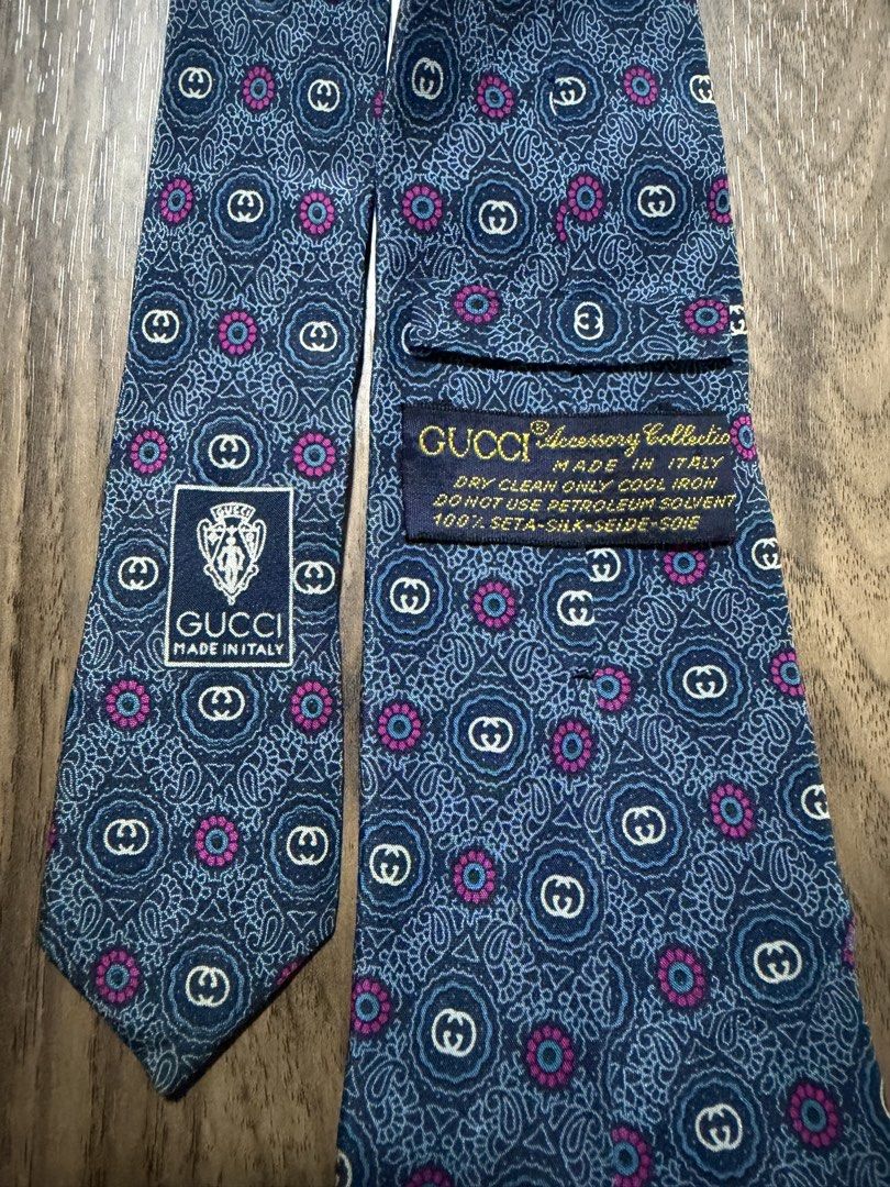 Gucci Accessory Collection Silk Tie (Category: Ties) located in Digos. Submitted by old_soul. (Listing ID 1470694961, Image 3). Description: - Brand: Gucci (Accessory Collection) - Material: 100% Silk (Made in Italy) - Design: Blue base with intricate paisley, GG monogram, and pink floral accents - Condition: Pre-loved in great, well-maintained condition - Ideal For: Formal events, office wear, meetings, and collectors - Shipping: LBC only.