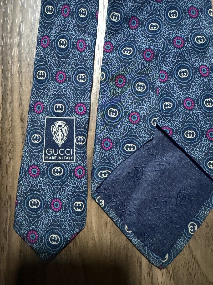 Gucci Accessory Collection Silk Tie (Category: Ties) located in Digos. Submitted by old_soul. (Listing ID 1470694961, Image 2). Description: - Brand: Gucci (Accessory Collection) - Material: 100% Silk (Made in Italy) - Design: Blue base with intricate paisley, GG monogram, and pink floral accents - Condition: Pre-loved in great, well-maintained condition - Ideal For: Formal events, office wear, meetings, and collectors - Shipping: LBC only.