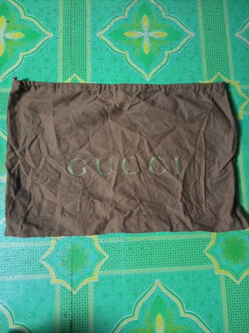 Gucci Brown Dust Bag (Category: Luxury Bags & Wallets) located in Manila. Submitted by youngbear.185ac4 (Listing ID 1470563089, Image 1). Description: - Authentic brown Gucci dust bag - Features a large printed Gucci logo on the front - Secure drawstring closure at the top - Made in Italy, 100% cotton with interior tag and care instructions - Great for storing luxury items, shoes, or handbags - Condition: Excellent.