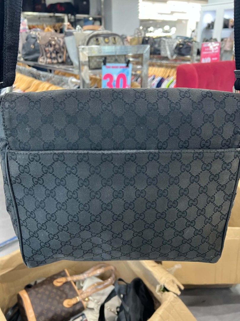 Gucci GG Monogram Canvas Messenger Bag Black (Category: Luxury Bags & Wallets) located in Urdaneta. Submitted by jayceegarage (Listing ID 1470693116, Image 2). Description: - Authentic Gucci messenger bag in classic black GG monogram canvas - Flap front design with secure magnetic closure and small leather logo patch - Adjustable black fabric shoulder strap for comfortable crossbody wear - Handy exterior slip pocket on the back for easy access - 