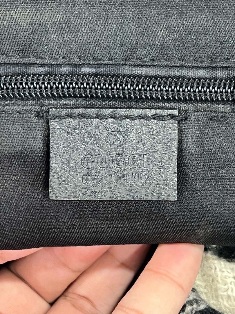 Gucci GG Monogram Canvas Messenger Bag Black (Category: Luxury Bags & Wallets) located in Urdaneta. Submitted by jayceegarage (Listing ID 1470693116, Image 3). Description: - Authentic Gucci messenger bag in classic black GG monogram canvas - Flap front design with secure magnetic closure and small leather logo patch - Adjustable black fabric shoulder strap for comfortable crossbody wear - Handy exterior slip pocket on the back for easy access - 