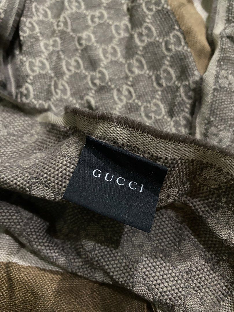 Gucci GG Monogram Wool Silk Scarf Brown (Category: Scarves) located in Pozorrubio. Submitted by izaykite2g (Listing ID 1470682941, Image 2). Description: - Authentic classic Gucci monogram scarf in brown and cream tones - 14 inches x 69 inches - Features the iconic GG pattern with stylish striped borders and fringed edges - Luxurious 80% wool and 20% silk blend for warmth and comfort - Dry clean only - Perfect accessory for cooler weather.