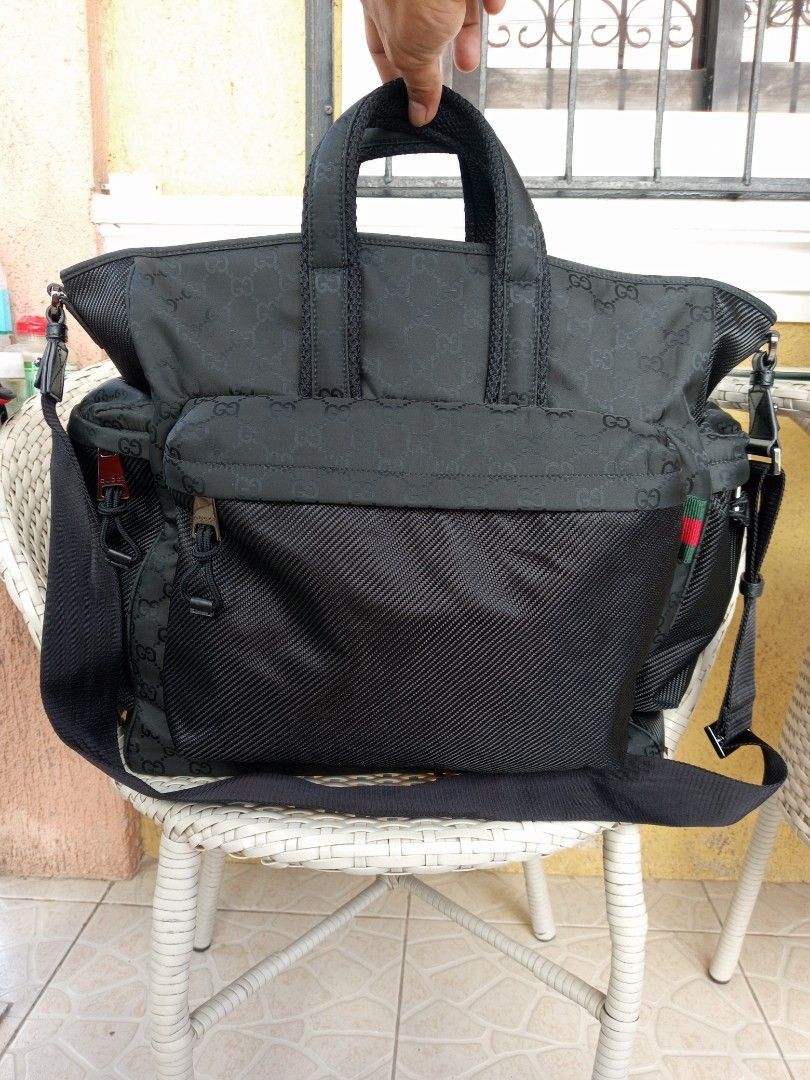 Gucci GG Nylon Black Tote Bag (Category: Luxury Bags & Wallets) located in Liloan. Submitted by dnznoon31 (Listing ID 1470594917, Image 2). Description: - Authentic Gucci GG nylon tote bag in classic black - Dimensions 14 x 15.5 inches - Subtle monogram pattern throughout - Dual top handles for easy carrying - Large front pocket and multiple side compartments for great organization - Practical and durable size ideal for daily use, travel, or work