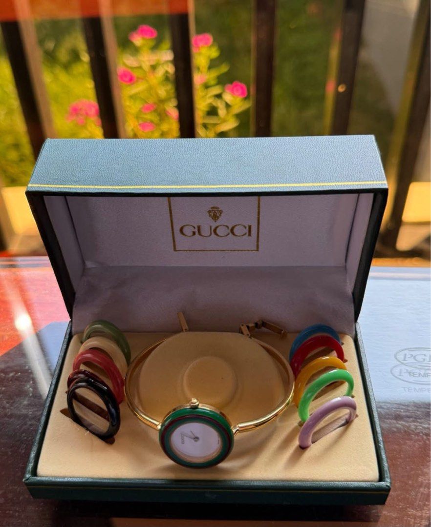 Gucci interchangeable bangle watch (Category: Women's Watches) located in Manila. Submitted by annafinds (Listing ID 1470651880, Image 2). Description: A vintage G quartz women’s watch set, featuring a gold-tone bangle case, a whit dial, and a set of interchangeable colored bezels. ₱22,500 Open for layaway. Disclaimer: We are not affiliated, associated, authorized, endorsed by or in any way officially connected with any other company or luxury br