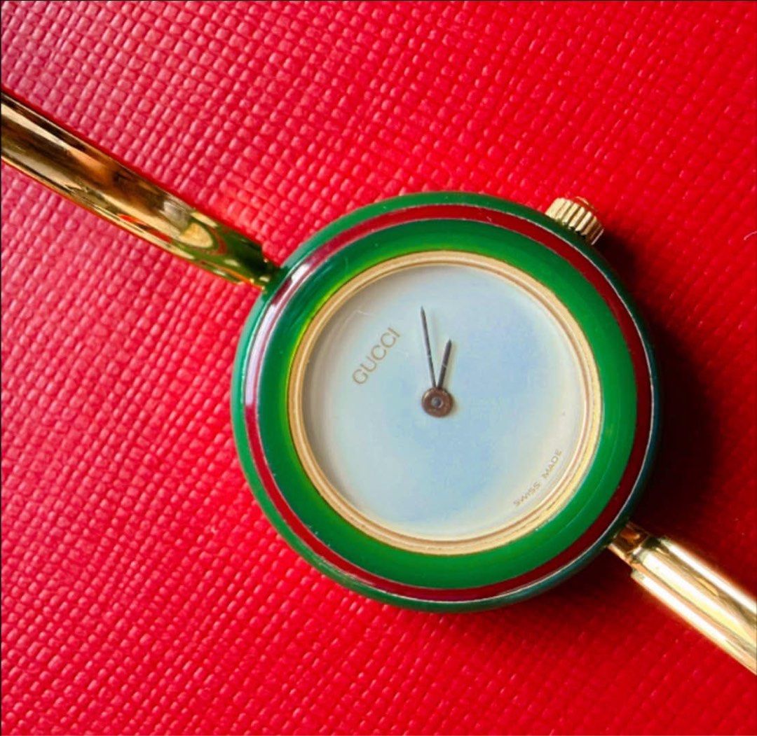 Gucci interchangeable bangle watch (Category: Women's Watches) located in Manila. Submitted by annafinds (Listing ID 1470651880, Image 3). Description: A vintage G quartz women’s watch set, featuring a gold-tone bangle case, a whit dial, and a set of interchangeable colored bezels. ₱22,500 Open for layaway. Disclaimer: We are not affiliated, associated, authorized, endorsed by or in any way officially connected with any other company or luxury br